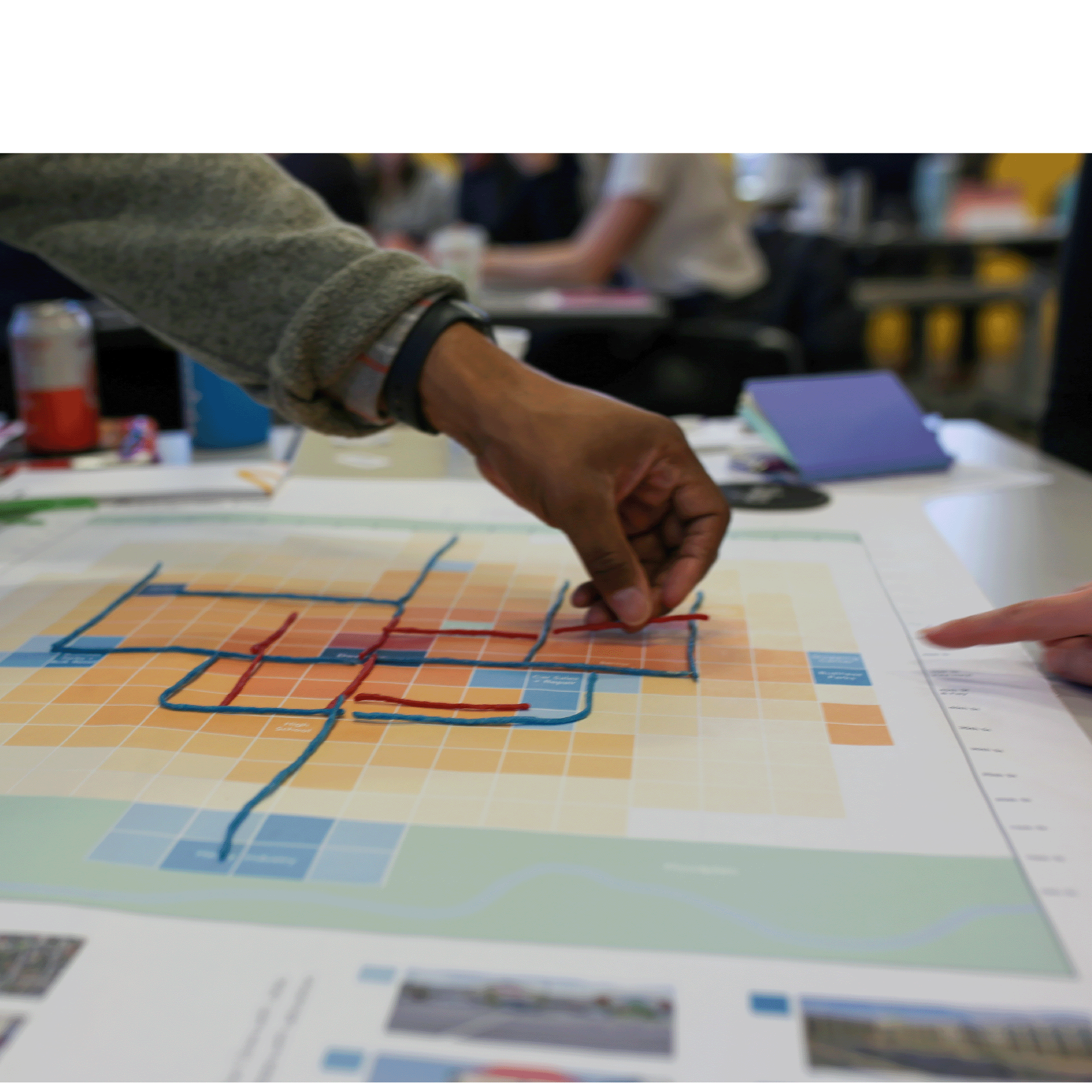 People doing a network planning exercise around a map of their city.