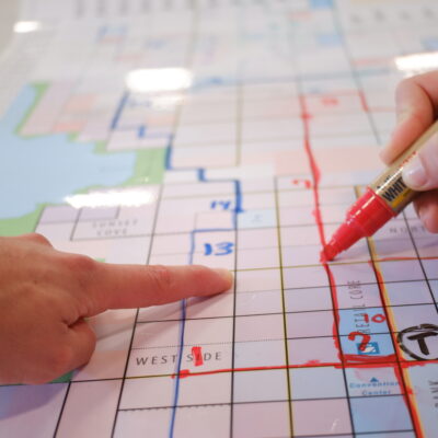 People doing a network planning exercise around a map of their city.