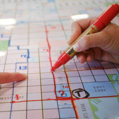 People doing a network planning exercise around a map of their city.